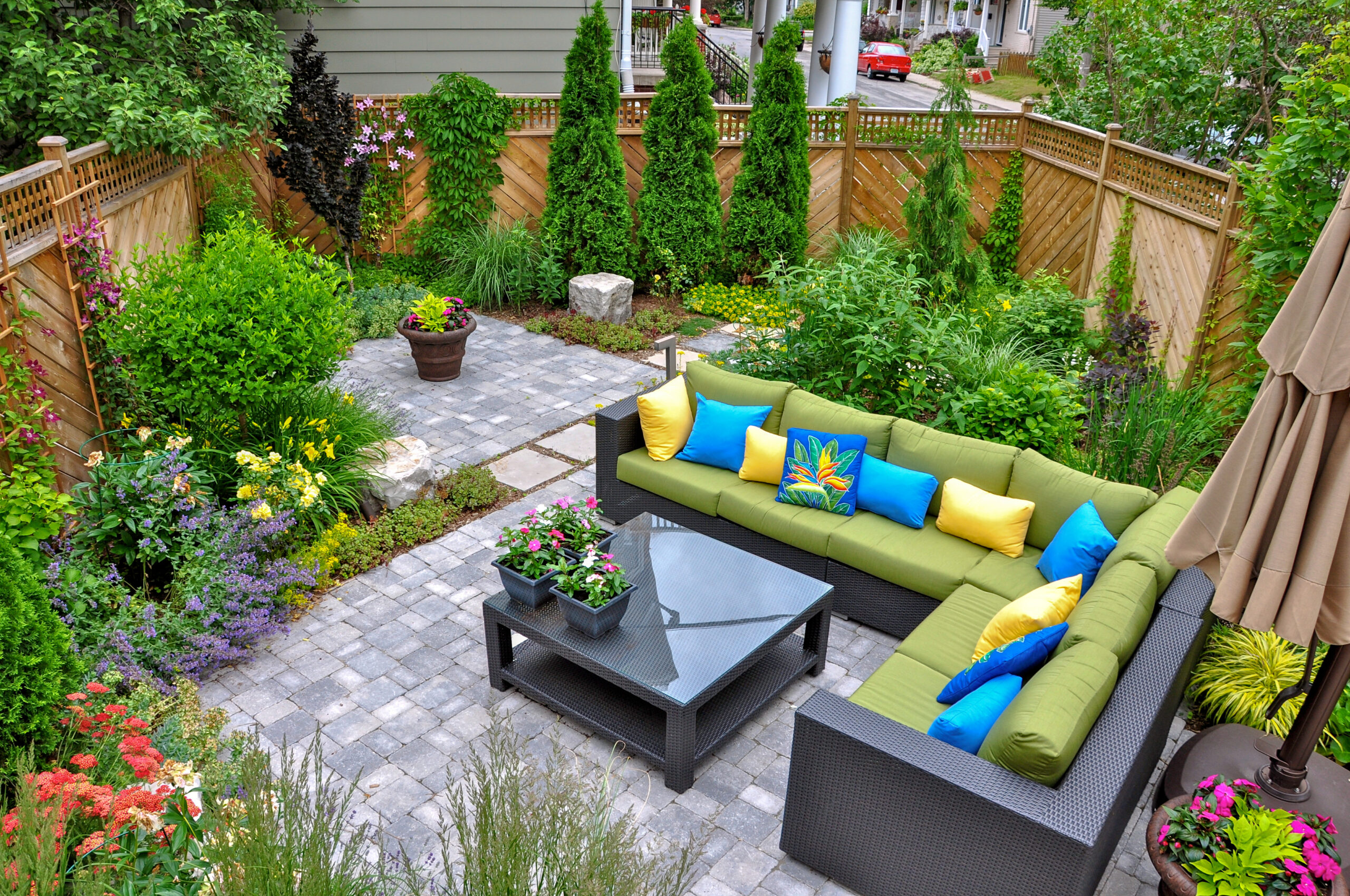 A beautiful small, urban backyard garden featuring a tumbled pav